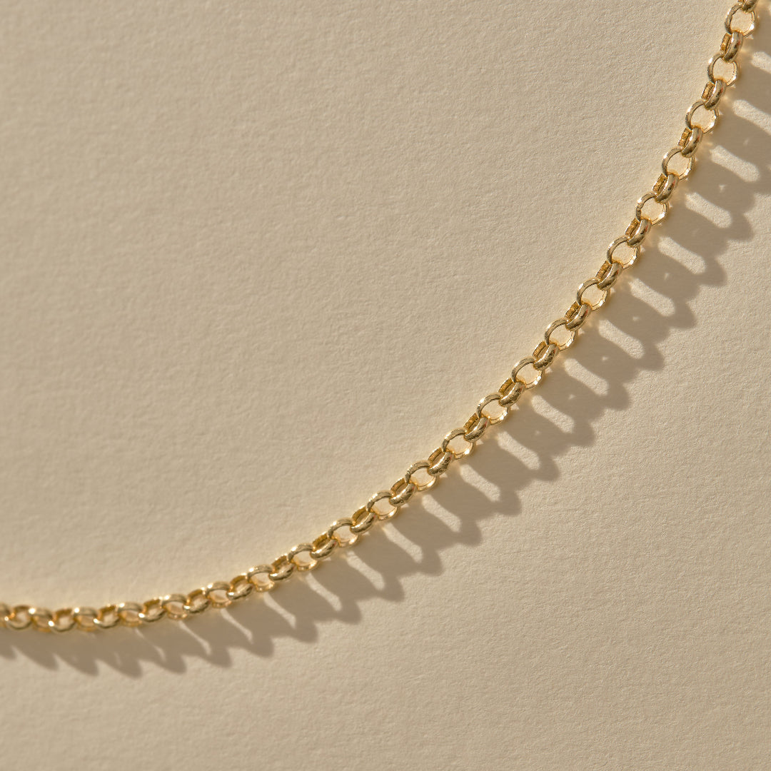Gold chain on a beige background