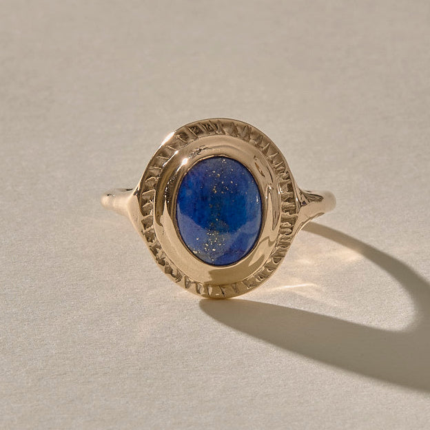 An elegant gold ring featuring an oval-shaped Lapis Lazuli stone set in a solid gold setting, with aRecycled 10k, 14k, or 18k gold option.