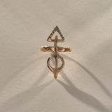 Gold ring with a unique design on a beige fabric background